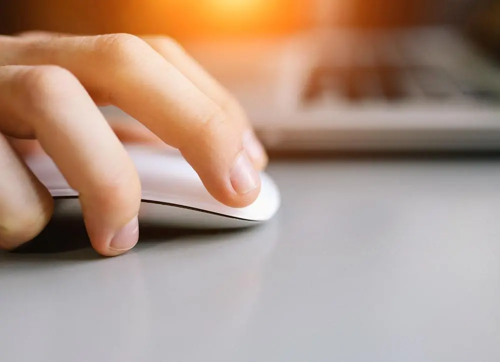 person holding a wireless mouse